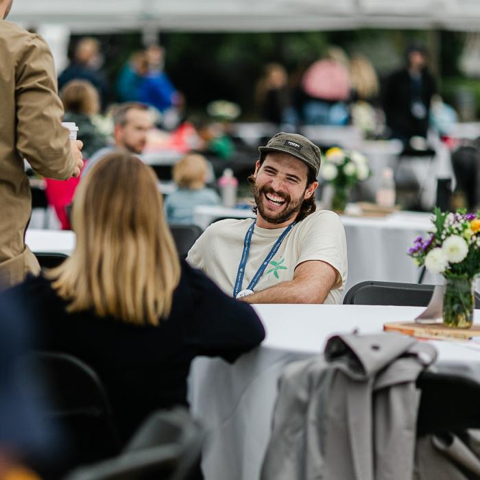 man sitting at table across from woman