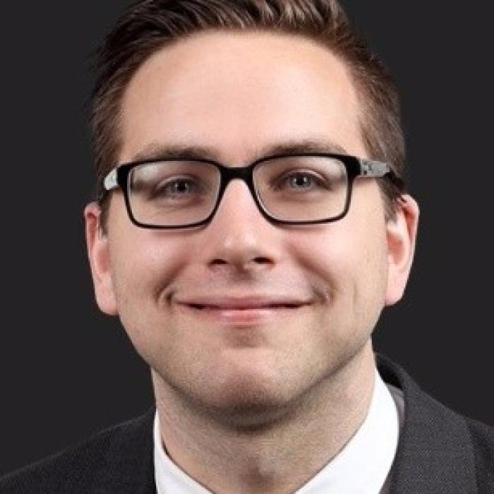 Headshot of a man wearing glasses