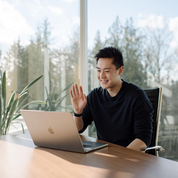 Student attending a virtual session on his computer.