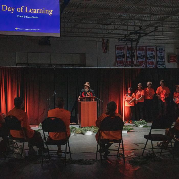 Day of Learning speaker talking in gym