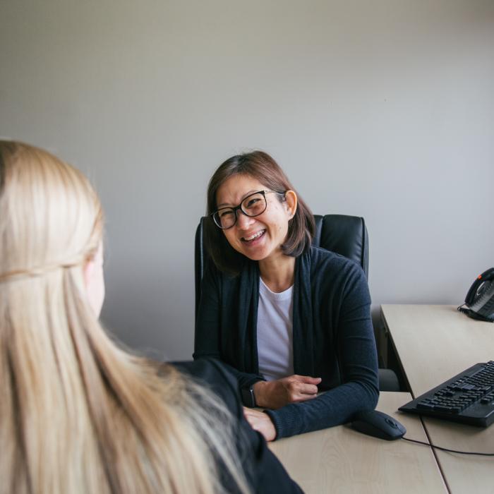Woman sitting at a desk for an interview