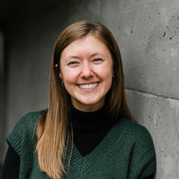 Reagan Lyle in front of a gray wall.