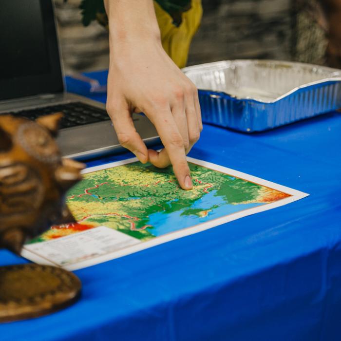Hand pointing at a map
