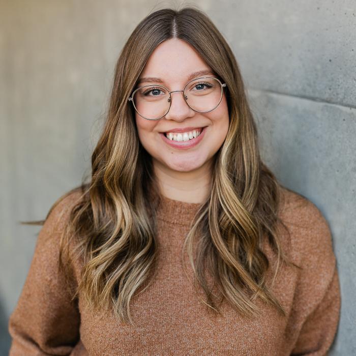 Natasha Hiebert in front of grey wall