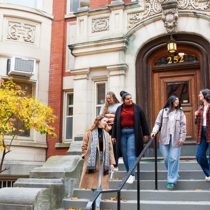 Students walking down the stairway of a building entrance