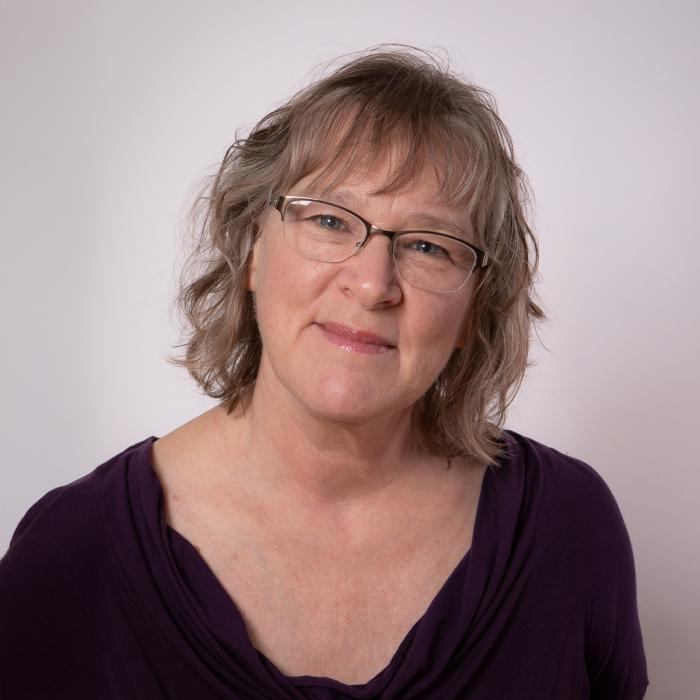 Darlaine Jantzen standing in front of a white wall