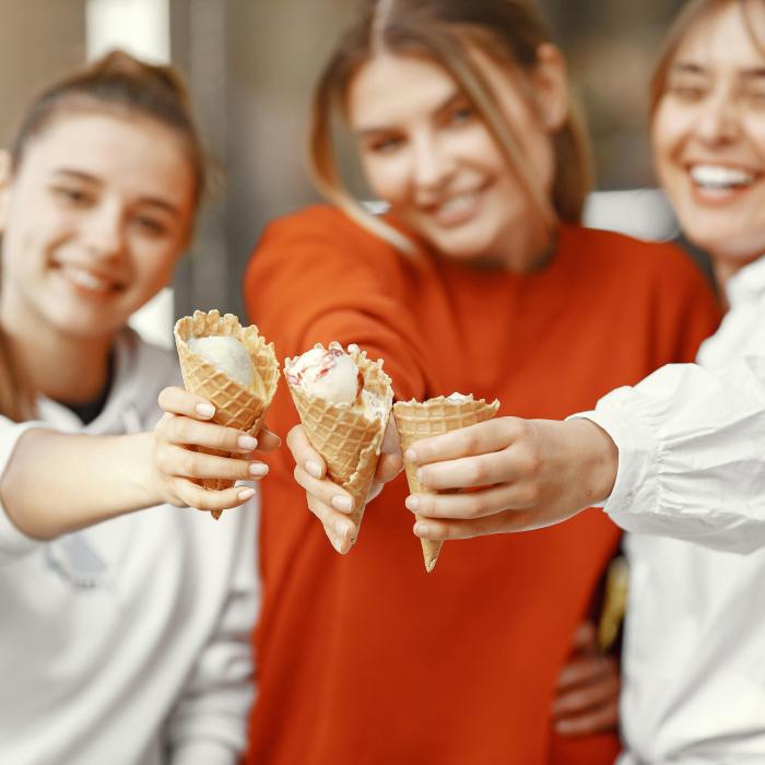 a group of girls holding icecream cones