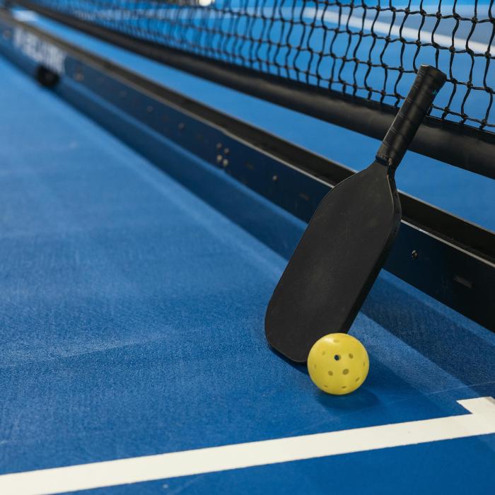 A pickleball paddle and net.