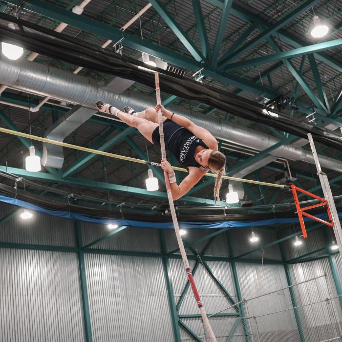 TWU athlete pole vaulting