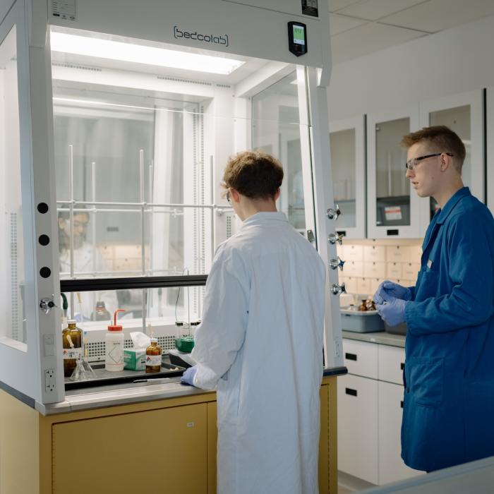 people working in a chemistry lab at TWU under a fume hood