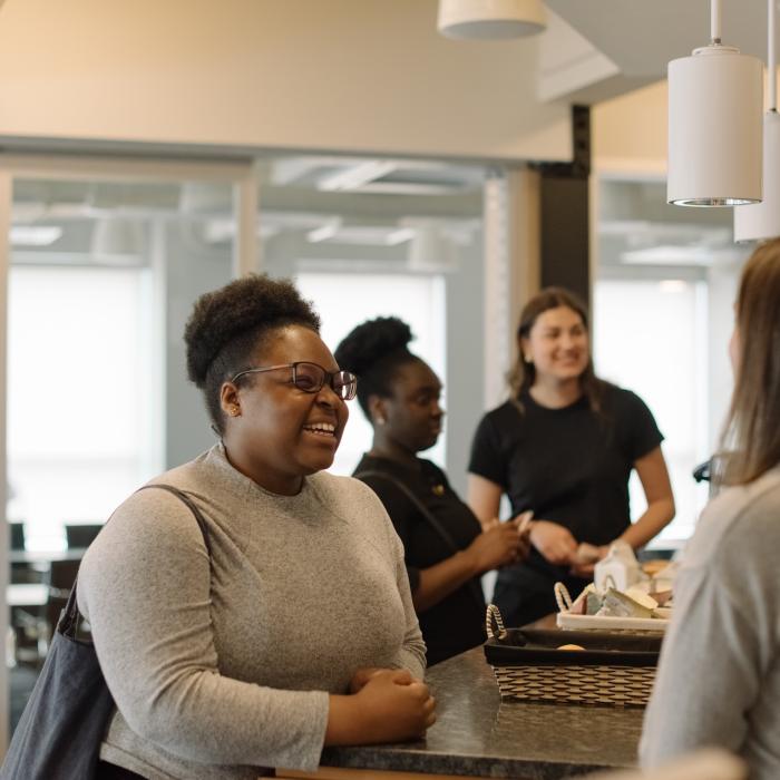 People smiling and talking in an office building