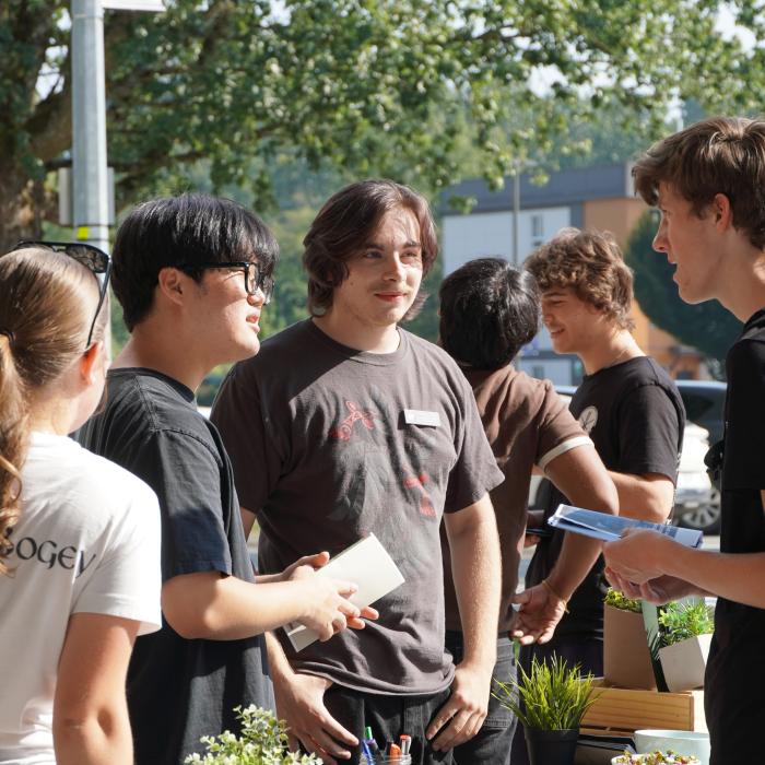 Students at a booth, talking.
