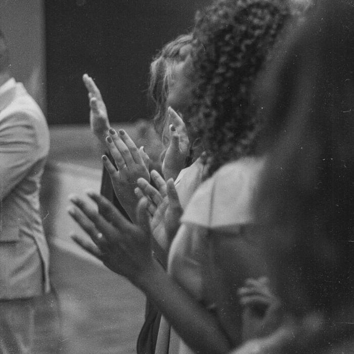 Black and white photograph of a group of people praying in worship
