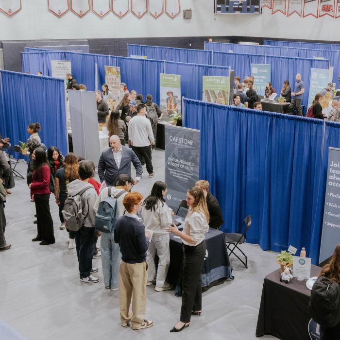 Career Fair setup in Gym with people at booths talking