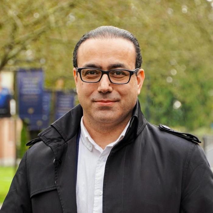 Hamid Delijani in front of trees on campus