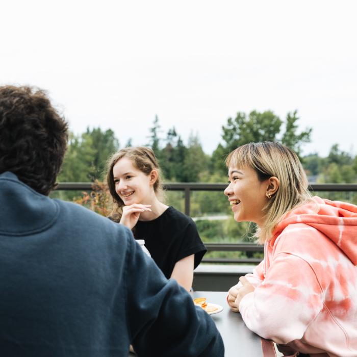 student sitting at table outside