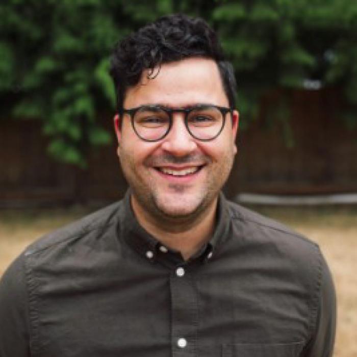 Michael Morelli with glasses on smiling towards the camera