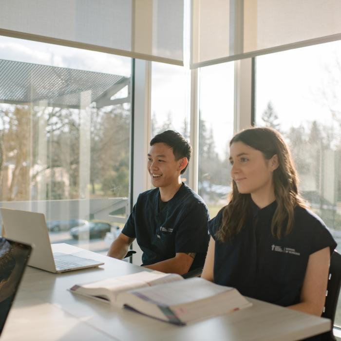 two school of nursing students in a classroom studying