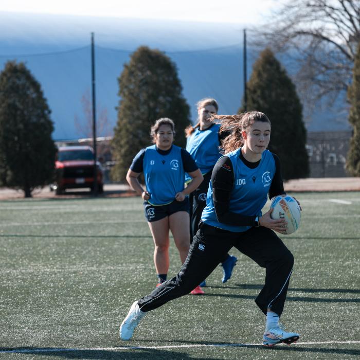 TWU girl students playing Rugby in the field