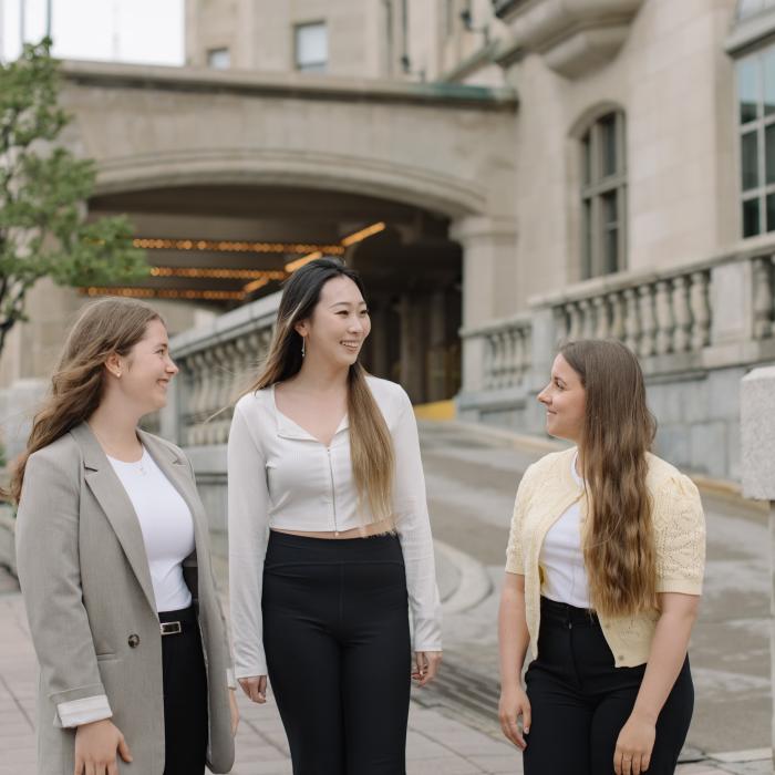Three Laurentian Leadership Centre students walking and talking outside in downtown Ottawa.